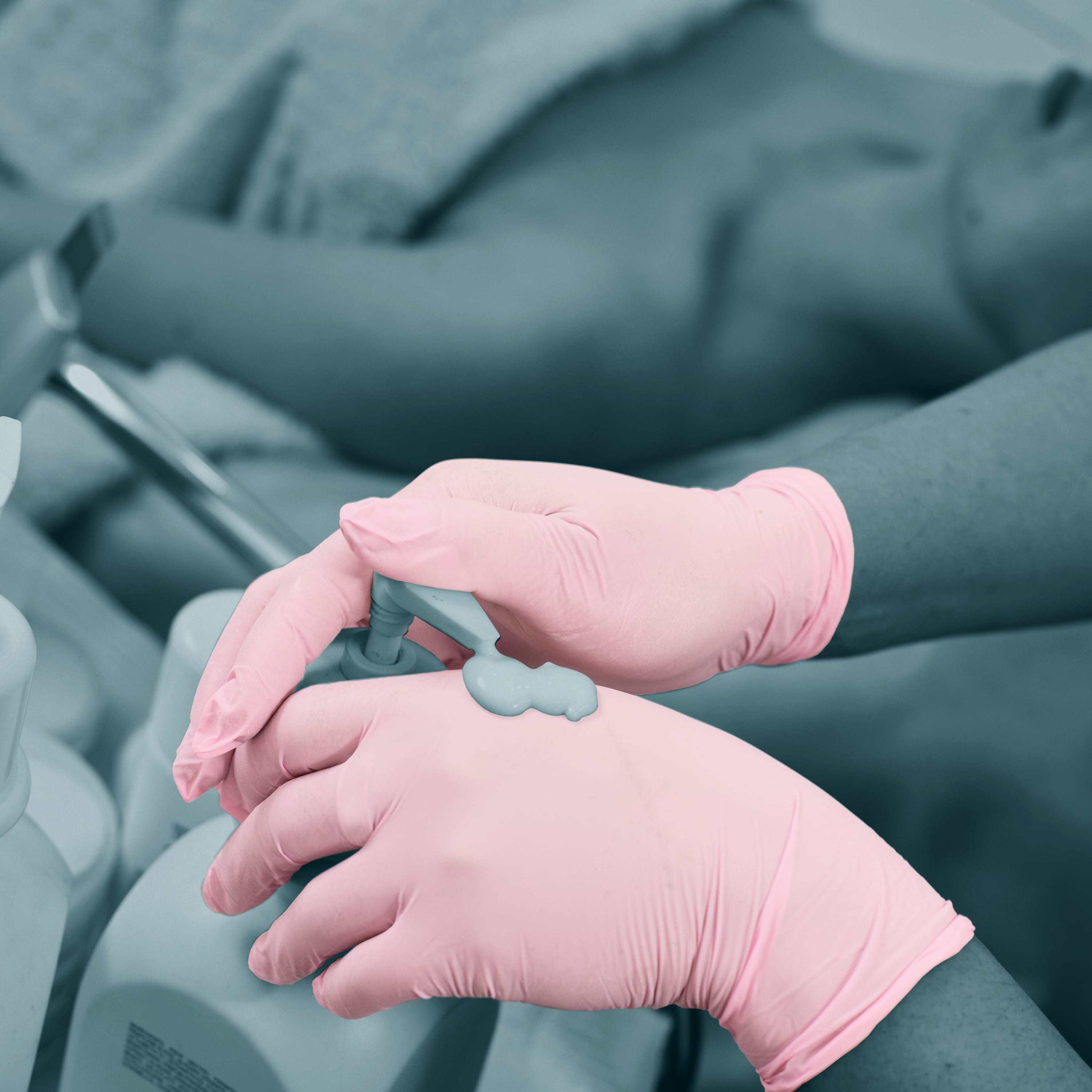 Applying tattoo glide on pink glove