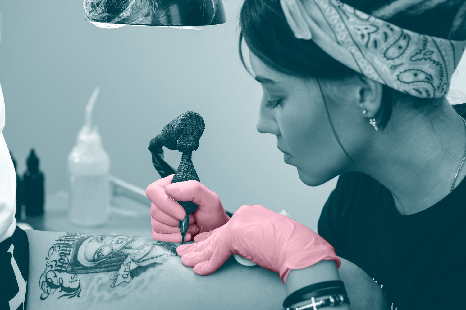 Tattoo artist with pink gloves