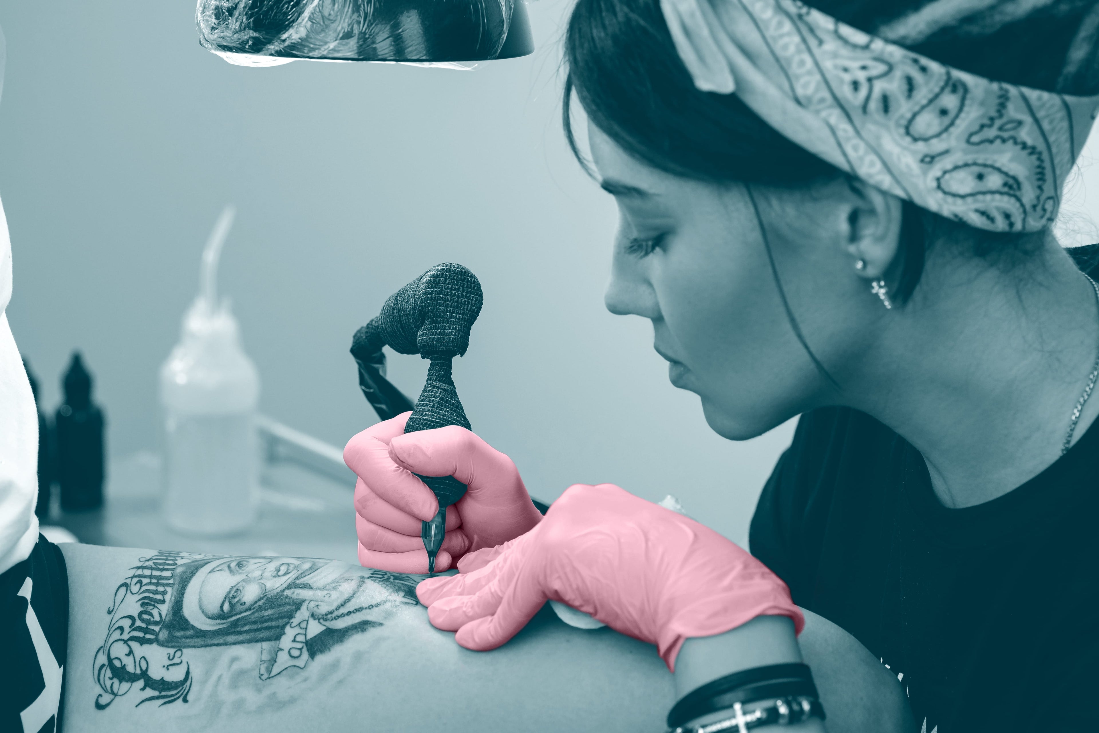 Tattoo artist with pink gloves