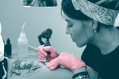 Tattoo artist with pink gloves